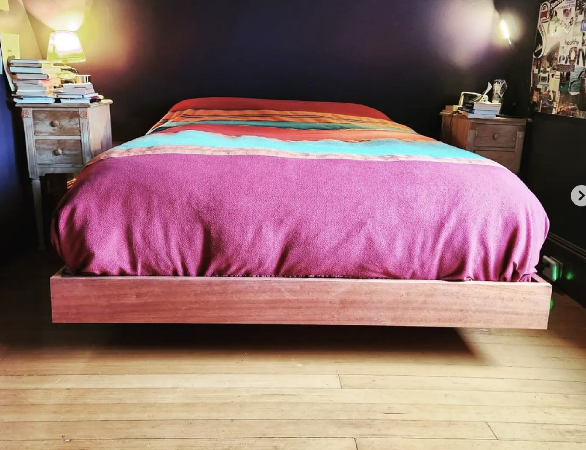 MissionCraft Furniture Basic Floating Bed with a solid hardwood platform and a vibrant multi-colored blanket