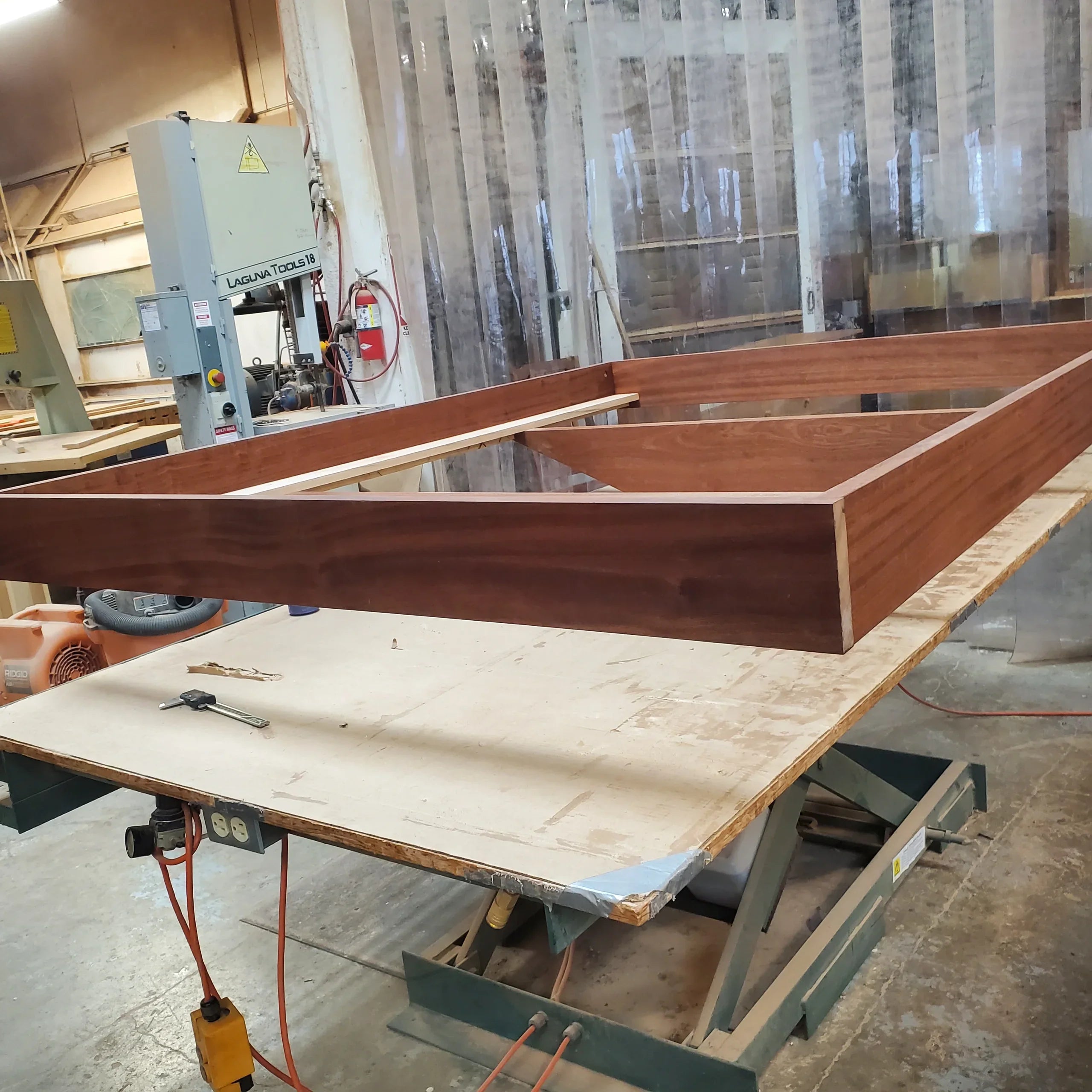MissionCraft Furniture Basic Floating Bed frame made of solid hardwood being assembled in a woodworking shop.