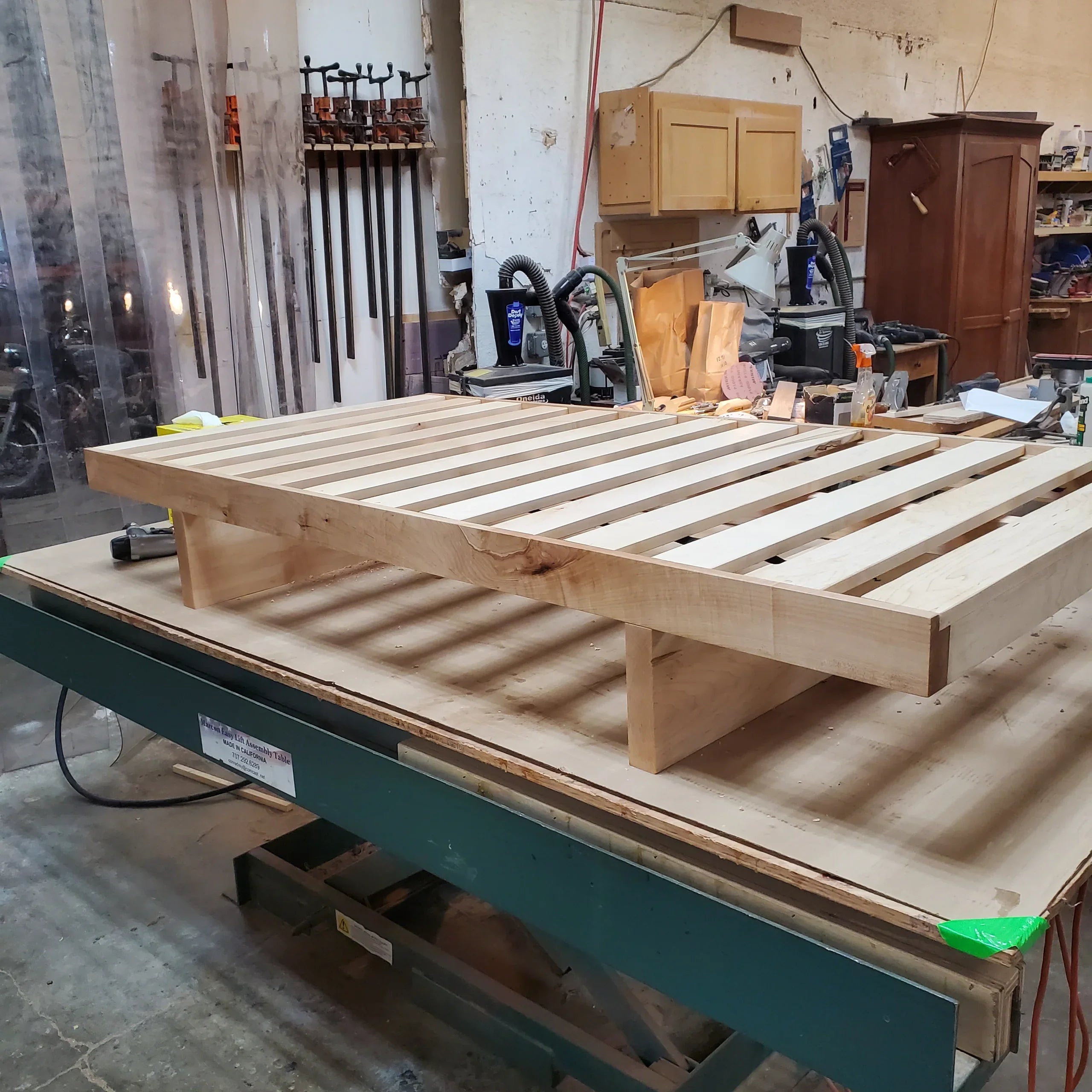 MissionCraft Furniture Kyoto Basic solid hardwood platform bed frame with slatted base in a woodworking workshop