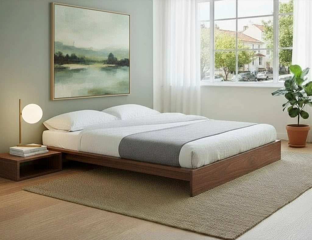 MissionCraft Furniture Pacifica low-profile solid walnut platform bed in a minimalist bedroom with white bedding.